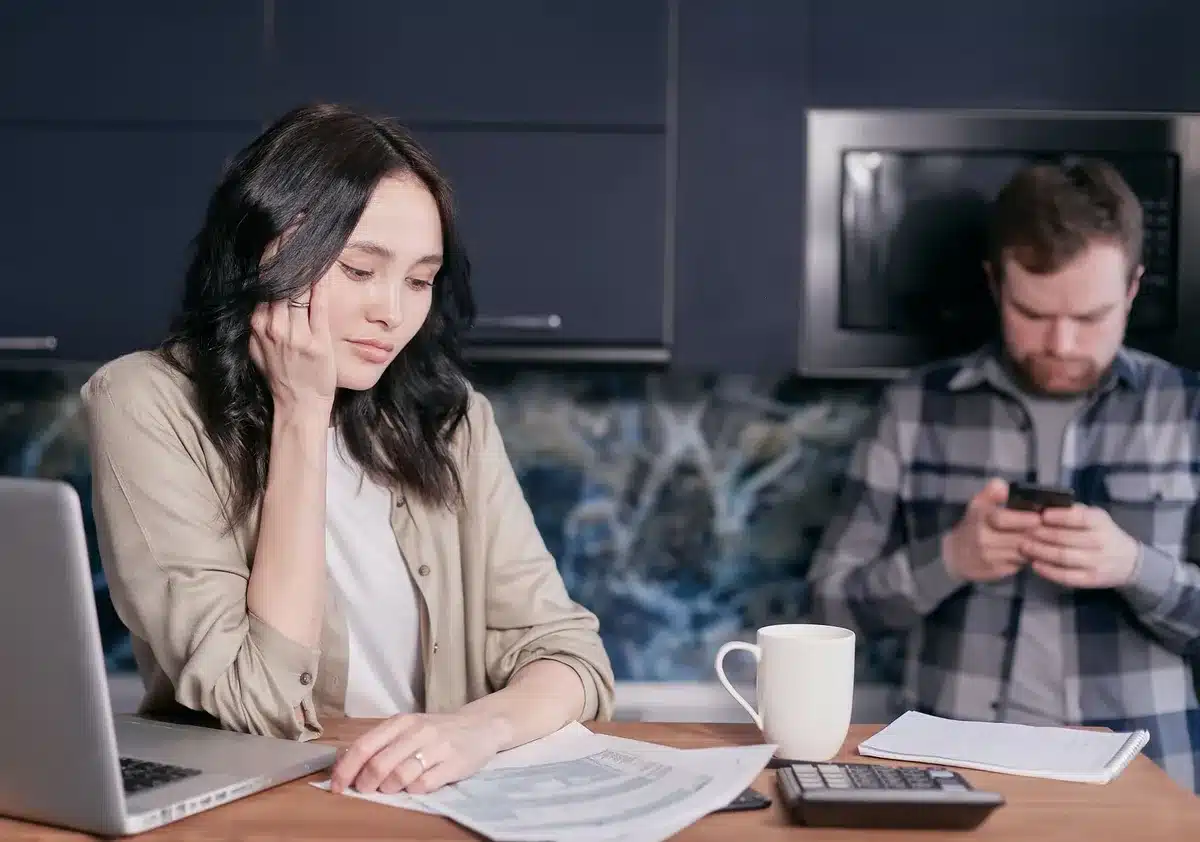 Person reviewing overdue auto loan bills and payment notices
