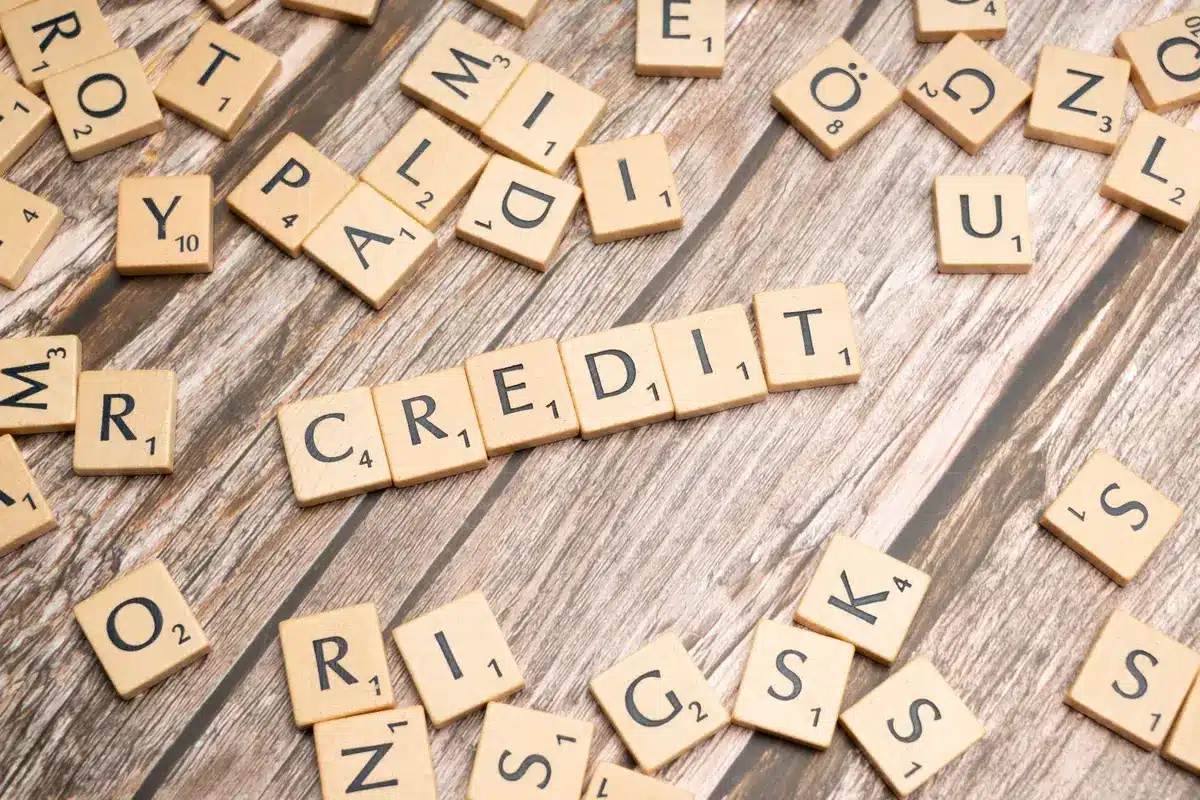 Financial analyst reviewing loan applications and credit risk data at computer