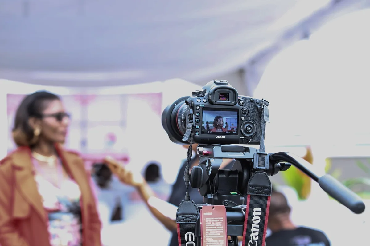 Journalist recording an interview with a microphone and laptop