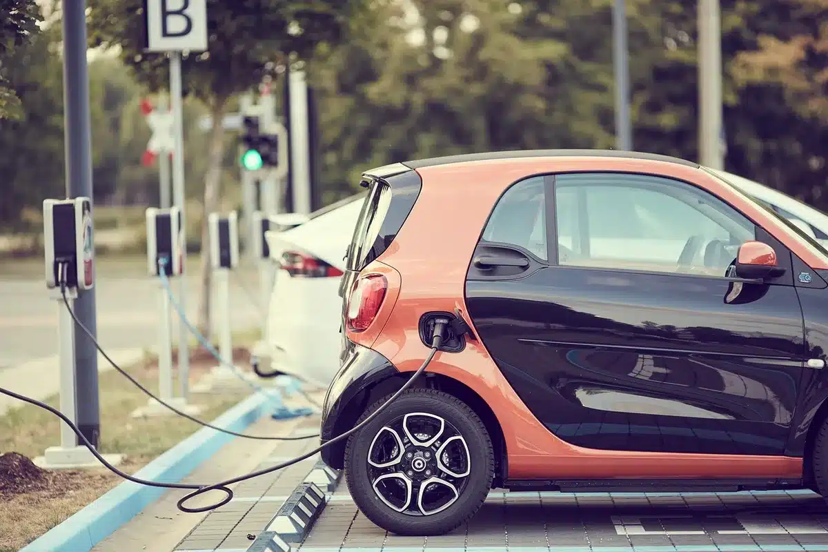Several parked electric cars at public chargers in daytime