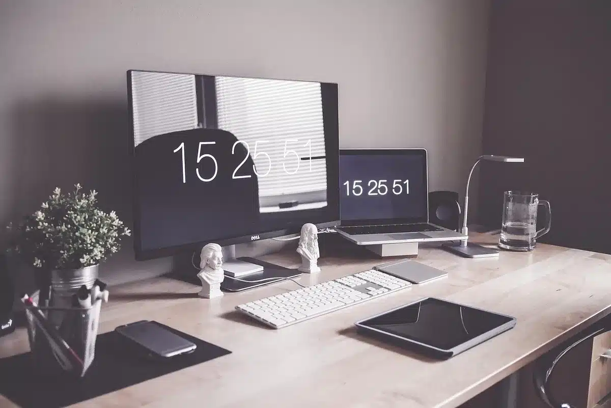 Modern newsroom workstation with multiple screens showing data and content management tools