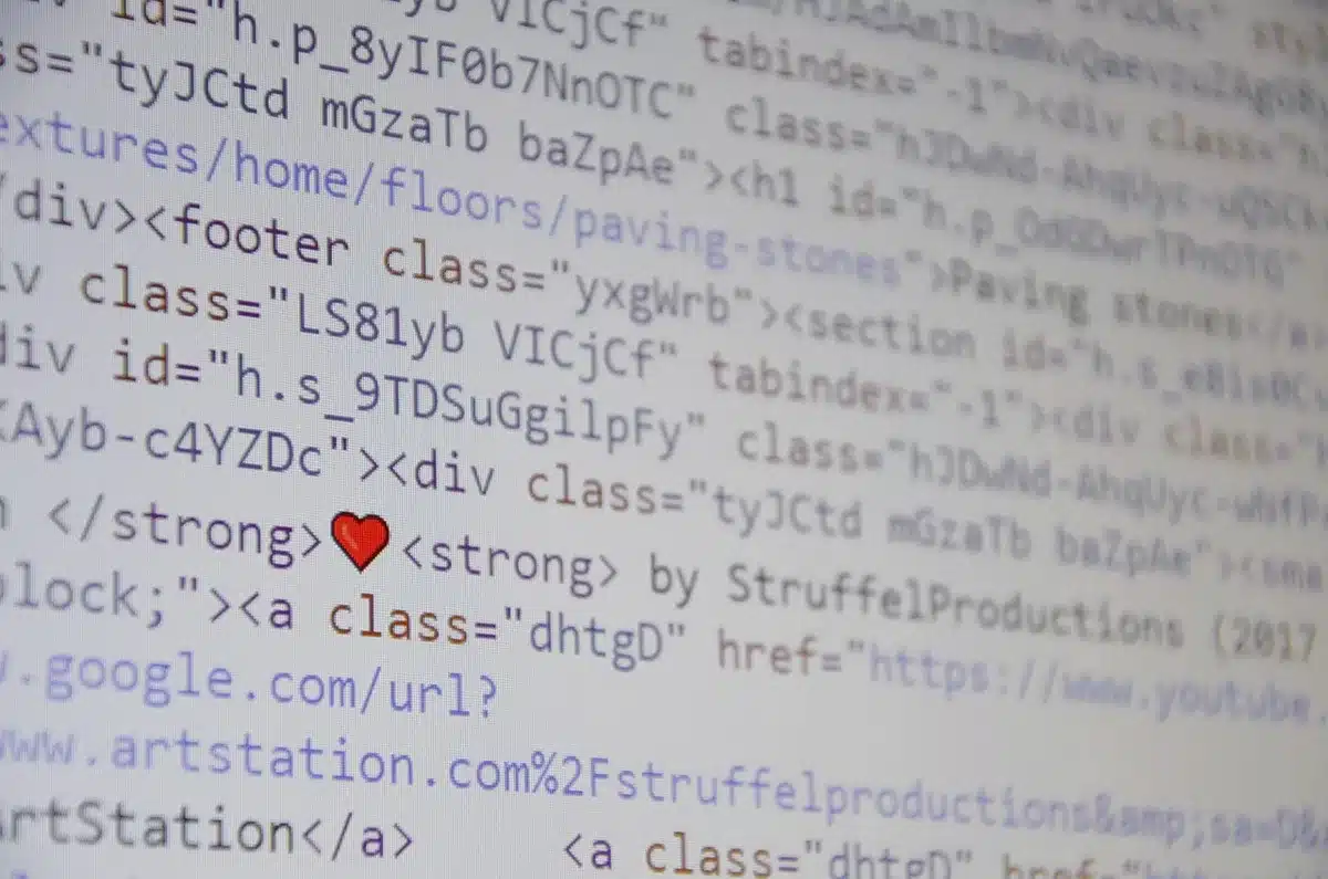 Developer at desk documenting code and checklists on a laptop