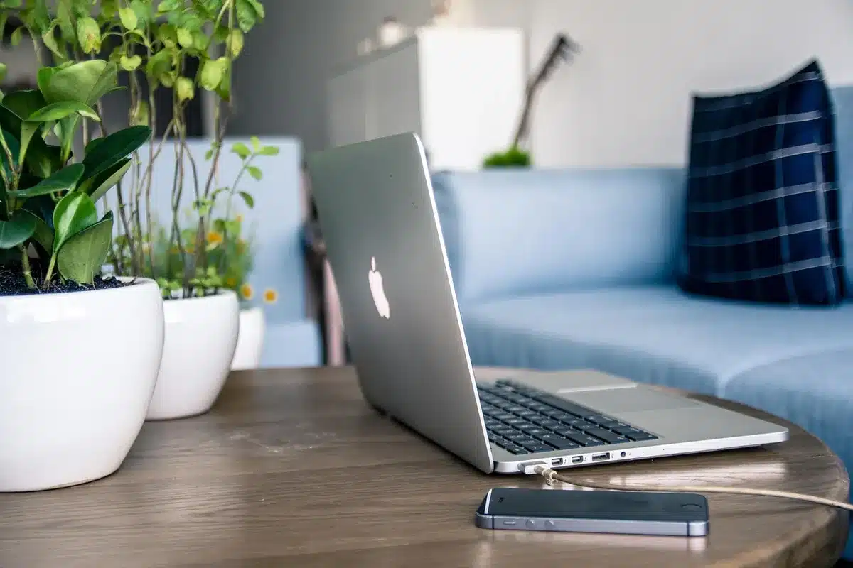 Editor adjusting a mobile layout on a laptop in daylight